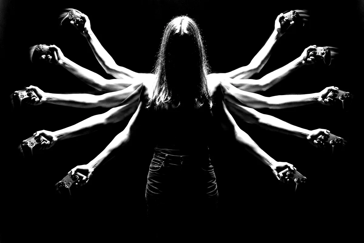 A figure with ten arms, each hand on a controller